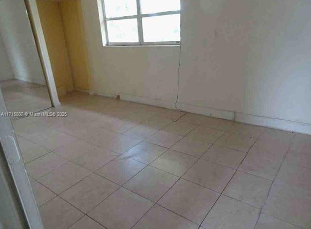 empty room with light tile patterned floors