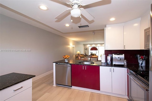 kitchen featuring stainless steel appliances, sink, and white cabinets