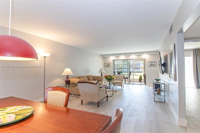 dining space with light wood-type flooring