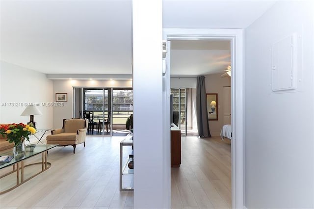 hall featuring electric panel and light hardwood / wood-style flooring