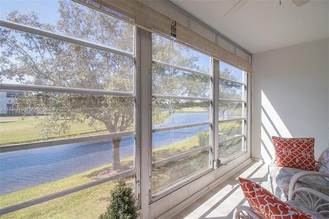 sunroom / solarium featuring a water view