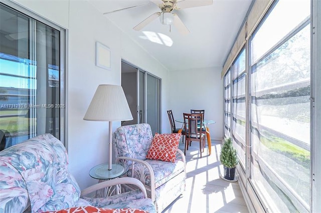 sunroom featuring ceiling fan