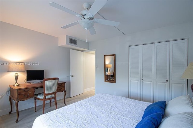 bedroom featuring ceiling fan, a closet, and light hardwood / wood-style flooring