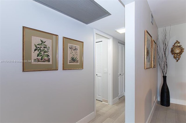 corridor with light hardwood / wood-style flooring