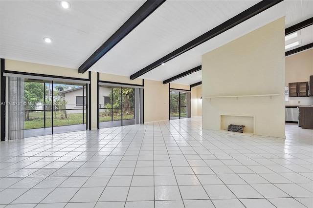 unfurnished living room featuring a healthy amount of sunlight, vaulted ceiling with beams, and light tile patterned floors