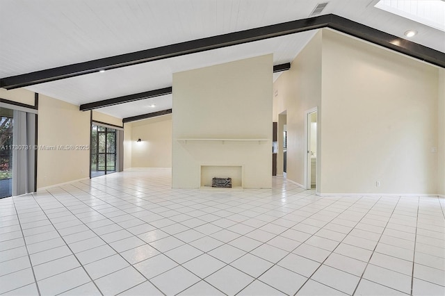 unfurnished living room with lofted ceiling with beams and light tile patterned floors