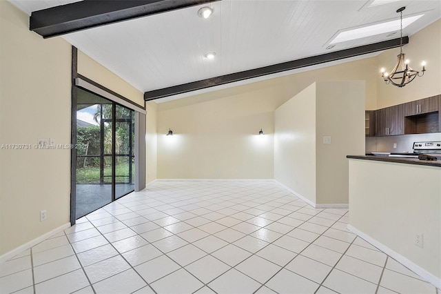 tiled empty room with lofted ceiling with beams and an inviting chandelier