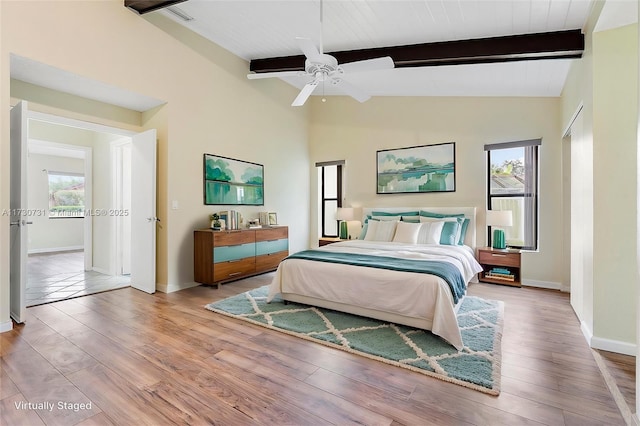 bedroom with vaulted ceiling with beams, wood ceiling, light hardwood / wood-style flooring, and ceiling fan