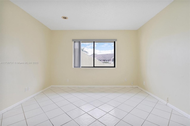 8017 NW 83rd Way, Tamarac, FL 33321 - empty room featuring light tile patterned floors and baseboards