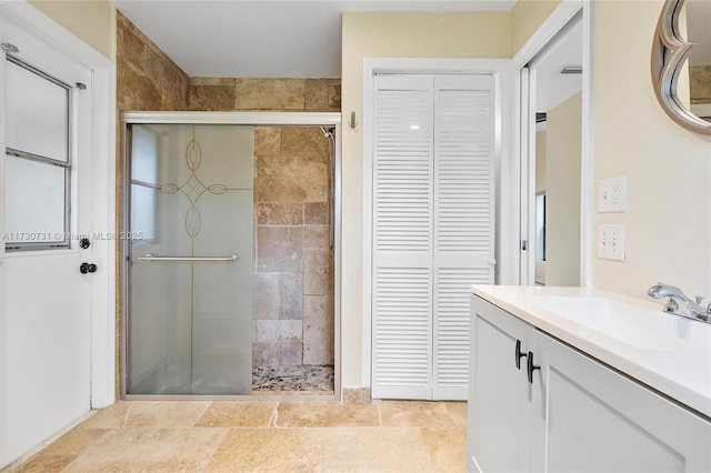 bathroom with vanity and a shower with shower door