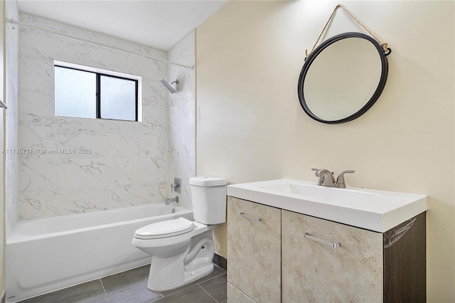 full bathroom featuring vanity, toilet, tiled shower / bath combo, and tile patterned flooring