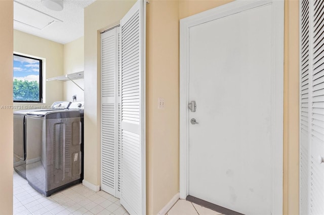 laundry area featuring light tile patterned flooring and separate washer and dryer