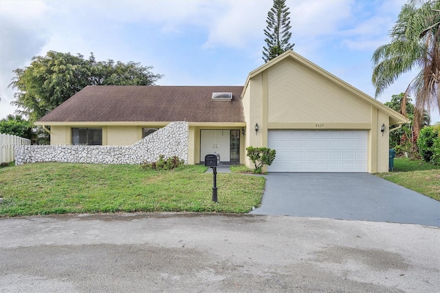 view of front of home featuring a garage and a front lawn