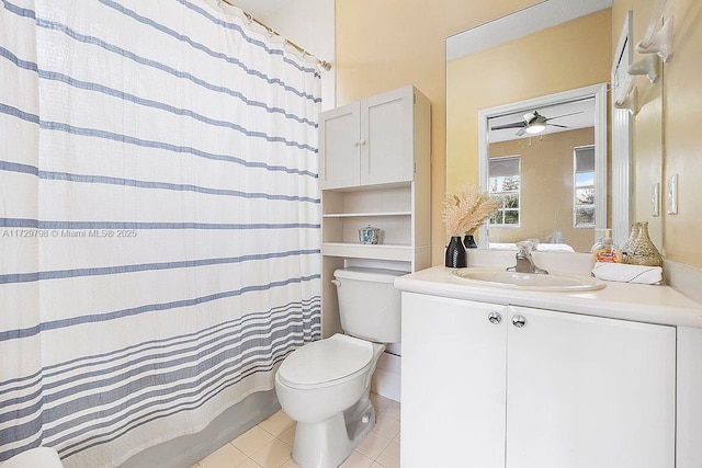 full bathroom with ceiling fan, shower / tub combo, vanity, tile patterned floors, and toilet