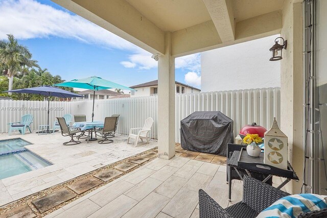 view of patio featuring a fenced in pool and a grill