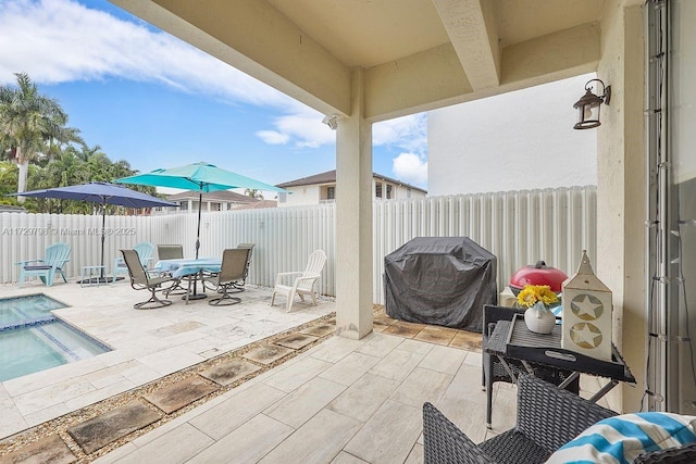 view of patio / terrace with outdoor dining space, a fenced backyard, and a grill