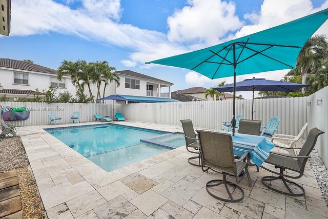 view of swimming pool featuring an in ground hot tub and a patio