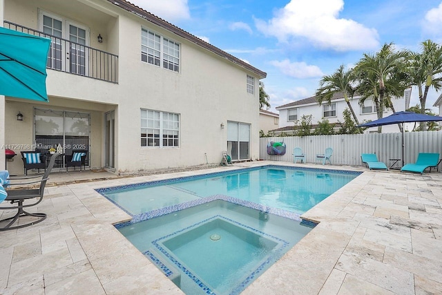 view of pool with an in ground hot tub and a patio area