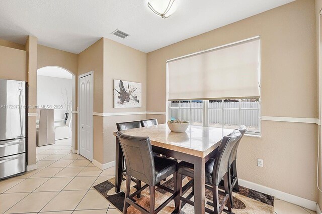 dining room with light tile patterned flooring