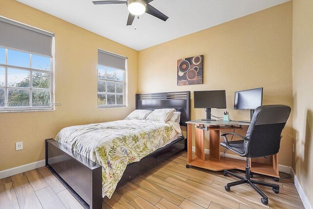 bedroom with ceiling fan and light hardwood / wood-style floors