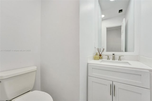 bathroom featuring toilet and vanity