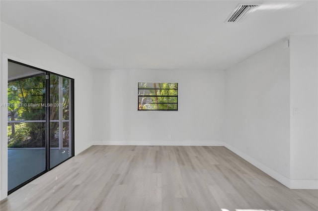 spare room featuring light hardwood / wood-style floors