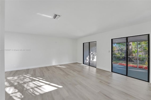 spare room featuring light hardwood / wood-style flooring