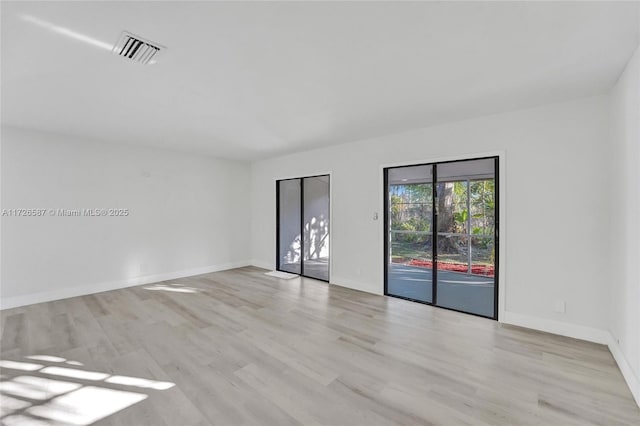 unfurnished room with light wood-type flooring