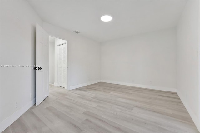 spare room with light wood-type flooring