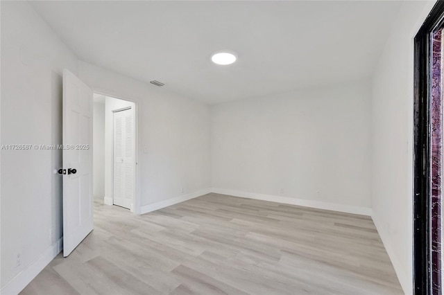 spare room featuring light wood-type flooring