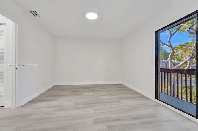 spare room with light hardwood / wood-style flooring