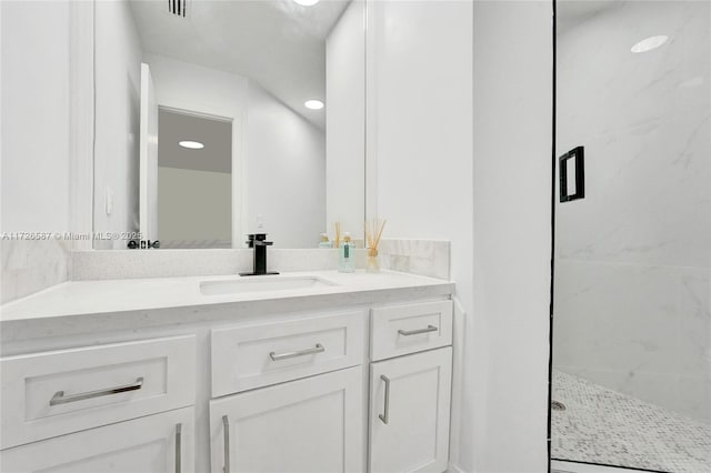 bathroom with vanity and a shower with shower door