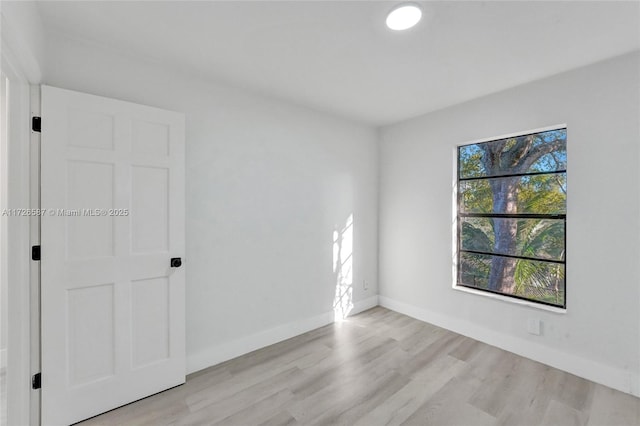 unfurnished room with light wood-type flooring