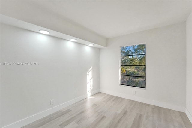 unfurnished room with light hardwood / wood-style floors