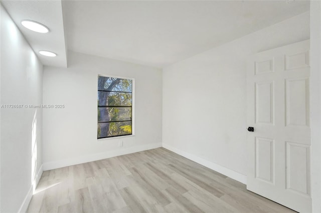 spare room featuring light wood-type flooring