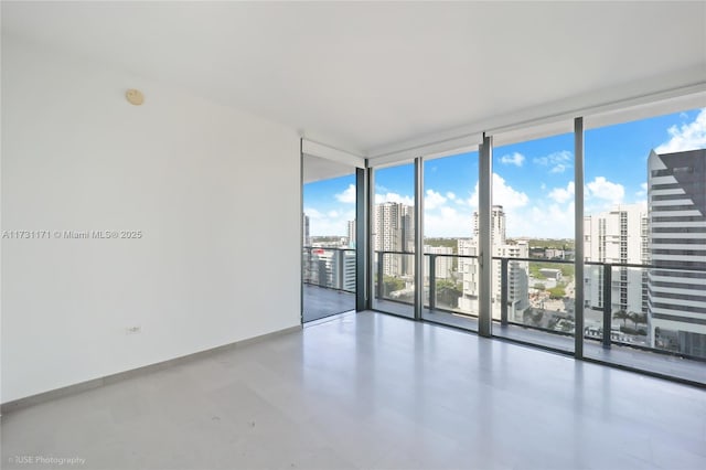 unfurnished room featuring floor to ceiling windows