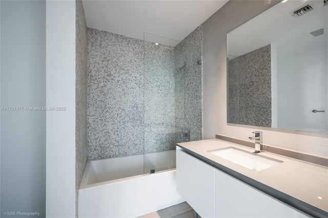 bathroom featuring vanity and shower / bath combination with glass door