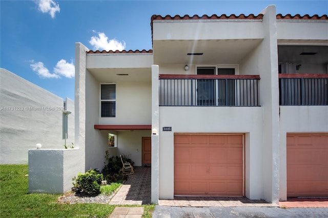 view of front facade with a balcony and a garage