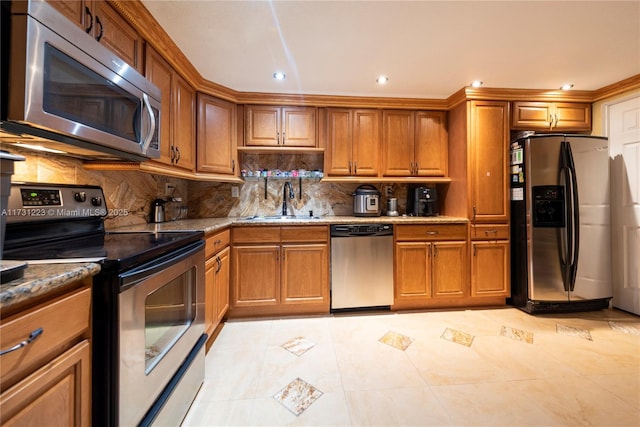 kitchen featuring sink, light tile patterned floors, appliances with stainless steel finishes, dark stone counters, and decorative backsplash