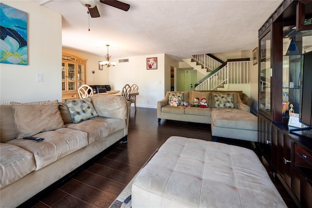 living room with ceiling fan with notable chandelier