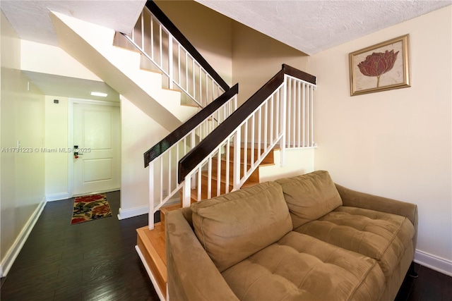 living room featuring dark hardwood / wood-style flooring and a textured ceiling