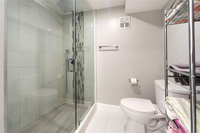 bathroom featuring toilet, tile patterned flooring, and a shower with door