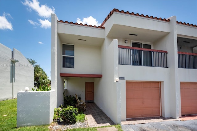 view of front facade with a garage and a balcony