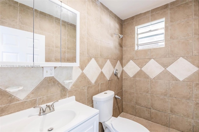 bathroom with vanity, toilet, and tiled shower