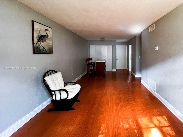 unfurnished room featuring hardwood / wood-style floors and a textured ceiling