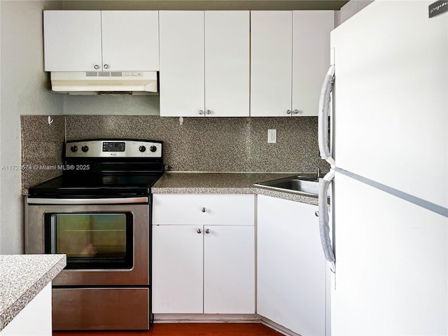 kitchen with stainless steel range with electric stovetop, decorative backsplash, white cabinets, and white fridge