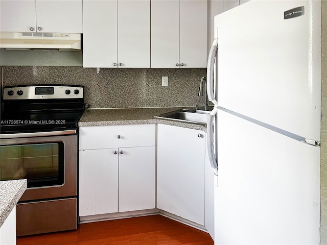 kitchen featuring white refrigerator, white cabinets, and stainless steel electric range