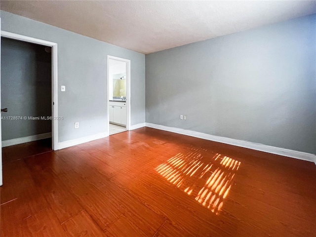 spare room with hardwood / wood-style flooring