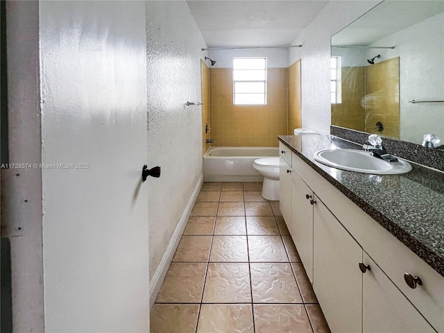 full bathroom with tiled shower / bath, vanity, toilet, and tile patterned floors