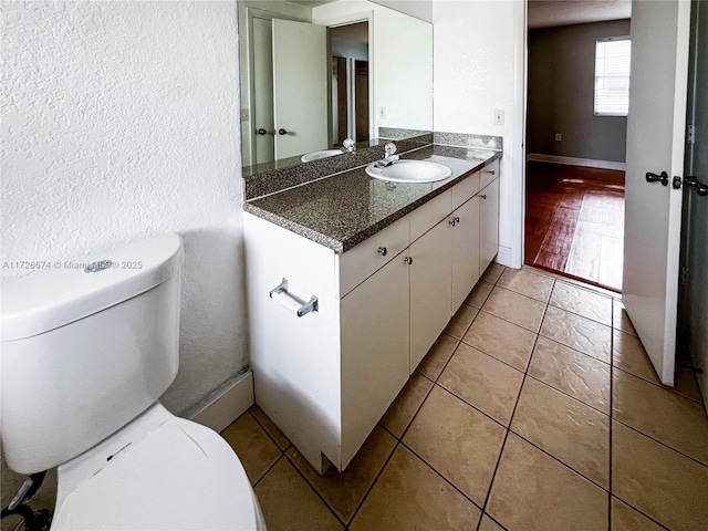 bathroom with vanity, tile patterned floors, and toilet